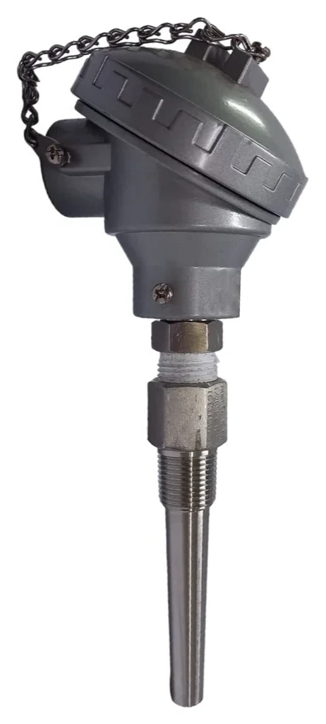 Thermocouple assembly with a grey cast terminal head and chained cap, fitted through a hex nipple to a stainless steel screwed thermowell, shown head up